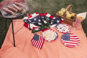 Fourth of July picnic table with flags and a barbecue grill